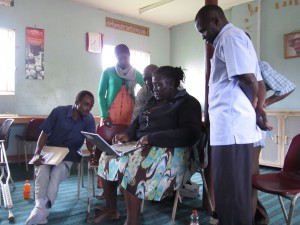 Staff from the Mayuge district education department are taken through an demonstration on the use of blogs